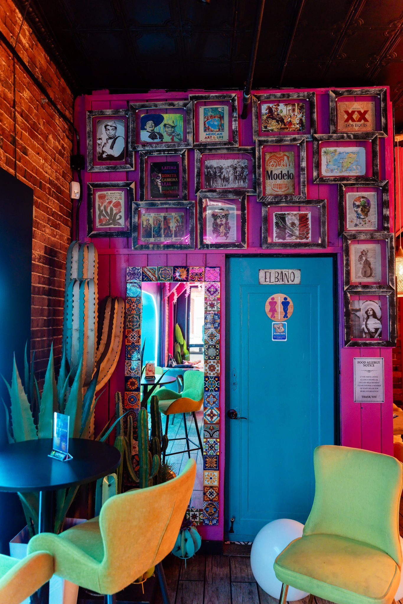 Framed wall and colorful seating in the lounge